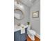 Half bathroom with blue vanity, modern fixtures, and updated lighting at 914 S Main St, Summerville, SC 29483
