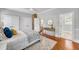 Comfortable bedroom with hardwood floors, white trim, and access to other rooms at 914 S Main St, Summerville, SC 29483