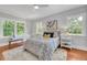 Bright bedroom with multiple windows, plush rug, and tasteful decor at 914 S Main St, Summerville, SC 29483
