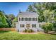 Charming two-story white home with black shutters, brick entryway, and well-manicured lawn at 914 S Main St, Summerville, SC 29483