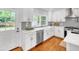 Modern kitchen with white cabinets, stainless steel appliances, and gray subway tile backsplash at 914 S Main St, Summerville, SC 29483
