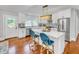 Bright, updated kitchen with white cabinets, island with seating, and stainless steel refrigerator at 914 S Main St, Summerville, SC 29483