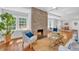 Bright living room with hardwood floors, brick fireplace, and a view into the dining area at 914 S Main St, Summerville, SC 29483