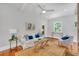 Comfortable living room with white sofa, area rug, ceiling fan, and natural light at 914 S Main St, Summerville, SC 29483