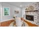 Cozy living area with whitewashed fireplace, comfortable seating, and natural light at 914 S Main St, Summerville, SC 29483