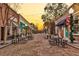 Charming street view with tables and chairs lining a brick street during golden hour at 914 S Main St, Summerville, SC 29483