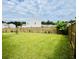 Spacious backyard with lush green grass, new wood fence, and landscaping at 9700 Flooded Field Drive Dr, Ladson, SC 29456