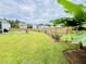 Beautiful backyard featuring lush green grass, a wooden fence, and a banana tree at 9700 Flooded Field Drive Dr, Ladson, SC 29456