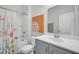 Bright bathroom featuring a shower-tub combination with curtain, neutral walls, and a stylish vanity at 9700 Flooded Field Drive Dr, Ladson, SC 29456
