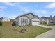 Charming home with tidy landscaping, a manicured lawn, and an attached two-car garage at 9700 Flooded Field Drive Dr, Ladson, SC 29456
