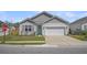 Charming one-story home features a teal front door, light gray siding, attached garage, and a well-manicured lawn at 9700 Flooded Field Drive Dr, Ladson, SC 29456