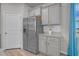 Bright kitchen area with stainless steel fridge, sleek cabinets, and granite countertop complemented by a window view at 9700 Flooded Field Drive Dr, Ladson, SC 29456