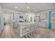 Spacious kitchen showcasing gray cabinets, granite countertops, and a large center island with pendant lighting at 9700 Flooded Field Drive Dr, Ladson, SC 29456