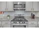Well-equipped kitchen with granite counters, stainless steel appliances, white subway tile backsplash, and ample cabinet space at 9700 Flooded Field Drive Dr, Ladson, SC 29456