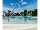 Community pool featuring water feature, lounge seating and mature trees in the background at 9700 Flooded Field Drive Dr, Ladson, SC 29456