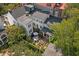 Aerial view of a home with a beautiful backyard, brick patio, outdoor seating, and lush greenery at 10 Water St, Charleston, SC 29401