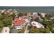 Aerial view of a residential area featuring colorful rooftops, mature trees, and a glimpse of the waterfront at 10 Water St, Charleston, SC 29401