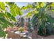 Charming backyard featuring a fountain, lush greenery, and outdoor seating nestled among banana trees at 10 Water St, Charleston, SC 29401