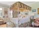 Light bedroom featuring a canopy bed with floral fabric and painted furnishings at 10 Water St, Charleston, SC 29401