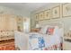 Comfortable bedroom featuring a colorful quilt, unique wardrobe, and framed art prints, creating a cozy atmosphere at 10 Water St, Charleston, SC 29401