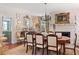 Charming dining room with a fireplace, chandelier, and formal table setting at 10 Water St, Charleston, SC 29401