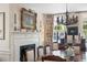 Elegant dining area with a fireplace, floral curtains, and vintage chandelier at 10 Water St, Charleston, SC 29401