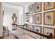 Elegant hallway featuring hardwood floors, white wainscoting, and decorative artwork at 10 Water St, Charleston, SC 29401