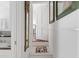 Hallway with white walls, a decorative rug, and an open door inviting exploration further into the home at 10 Water St, Charleston, SC 29401