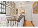 Hallway with hardwood floors, a gallery wall, and elegant lighting at 10 Water St, Charleston, SC 29401