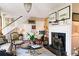 Cozy living room with a fireplace, floral armchairs, and decorative art at 10 Water St, Charleston, SC 29401