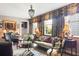 Bright living room with floral window coverings, a chandelier, and comfortable seating at 10 Water St, Charleston, SC 29401