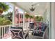 Inviting porch with comfortable seating, ferns, and views of the neighboring property at 10 Water St, Charleston, SC 29401