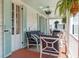Relaxing porch with plush seating, pendant lighting, and classic architecture at 10 Water St, Charleston, SC 29401