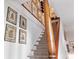 Stairway with carpeted steps, a wooden handrail, and decorative wall art at 10 Water St, Charleston, SC 29401