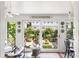 Bright sunroom with lush garden views and comfortable seating at 10 Water St, Charleston, SC 29401