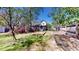 Fenced backyard featuring a well-maintained lawn, landscaping, a screened porch, and mature trees at 103 Haleswood Cir, Goose Creek, SC 29445
