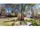 Lush backyard featuring a well-maintained lawn, mature trees, and a storage shed at 103 Haleswood Cir, Goose Creek, SC 29445