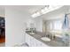 Bright bathroom featuring dual sinks, granite countertops, a walk-in shower and soaking tub at 103 Haleswood Cir, Goose Creek, SC 29445