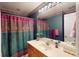 Eclectic bathroom with bold wallpaper, vanity, mirror, and patterned shower curtain at 103 Haleswood Cir, Goose Creek, SC 29445