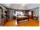 Spacious main bedroom featuring tray ceilings, hardwood floors, and classic wood furnishings at 103 Haleswood Cir, Goose Creek, SC 29445