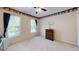 Neutral bedroom with matching dark wood dresser, and light filtering through the windows at 103 Haleswood Cir, Goose Creek, SC 29445