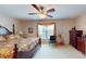 Cozy primary bedroom featuring a ceiling fan, window, furniture, and wallpapered accent wall at 103 Haleswood Cir, Goose Creek, SC 29445