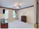 Spacious bedroom with soft carpet, two windows, ceiling fan, and decoratively wallpapered border at 103 Haleswood Cir, Goose Creek, SC 29445