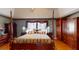 Well lit bedroom featuring a four-poster bed, hardwood floors, and dual bedside tables at 103 Haleswood Cir, Goose Creek, SC 29445
