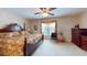 Comfortable bedroom with neutral carpet, a large window, and classic wood furnishings at 103 Haleswood Cir, Goose Creek, SC 29445