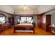 This primary bedroom features a four-poster bed, hardwood floors, and warm decor at 103 Haleswood Cir, Goose Creek, SC 29445