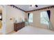 Bright bedroom with neutral carpet, a ceiling fan, and a decorative border at 103 Haleswood Cir, Goose Creek, SC 29445