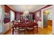 Dining room with an elegant chandelier, rich red walls and hardwood floors at 103 Haleswood Cir, Goose Creek, SC 29445