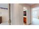 Hallway view highlighting bathroom and bedroom entrances with carpeted floors and bright neutral walls at 103 Haleswood Cir, Goose Creek, SC 29445