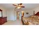Spacious primary bedroom featuring a ceiling fan, furniture, and doorway to the en-suite bathroom at 103 Haleswood Cir, Goose Creek, SC 29445